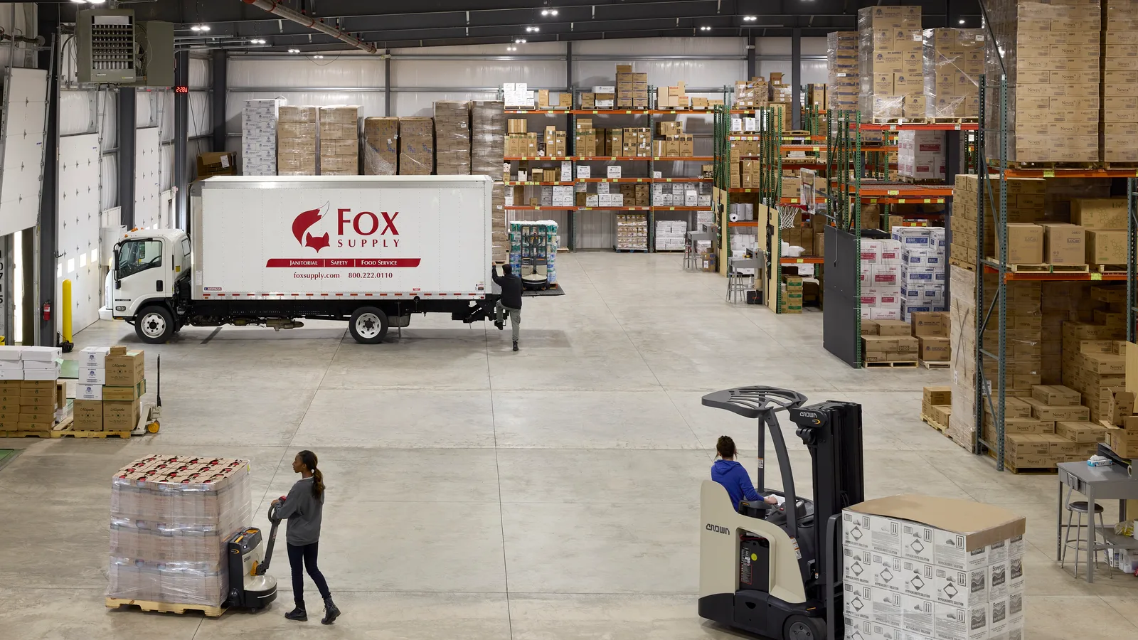 Crown electric forklift working a distribution warehouse aisle